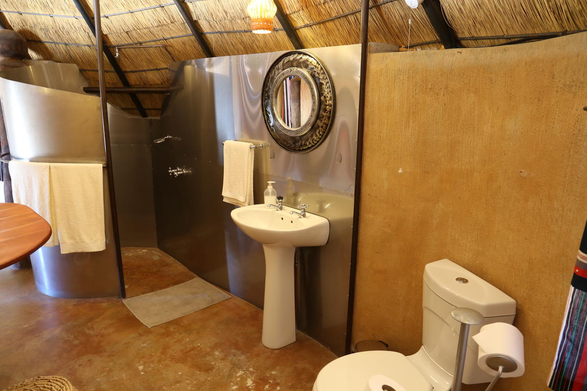 img_06891 a bathroom with a toilet, sink and shower